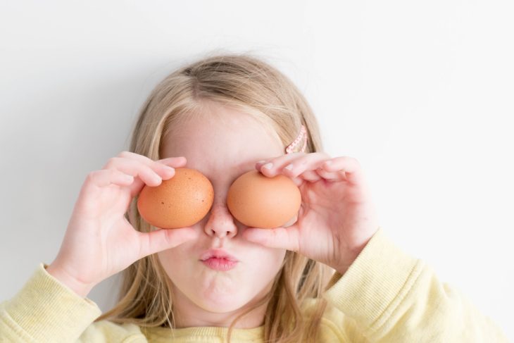 Female Child holding Brown Eggs